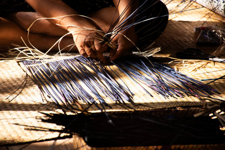 Thai craftsmanship technician and professional local artisan knitting wicker unique handmade krachut or sedge products for show and sale in crafts studio workshop at Thale Noi in Phatthalung, Thailandの写真素材
