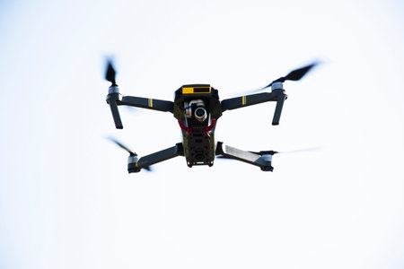 Surveillance drone or unmanned aerial vehicle UAV with camera and camcorder video record flying in sunflower garden park field in rural countryside of Saraburi and Lopburi city at Lop buri, Thailandの写真素材