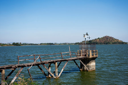 View landscape with old water level measurement station and broken damage wooden bridge in lake dam of Phu Sub Lek catchment with freshness environment on crest reservoir in Lopburi, Thailandの写真素材