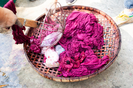 Thai people travelers study learning batik ikat and tie dye natural pink color from boil shellac...