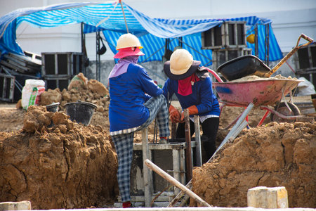 Asian labor people thai labour workers use machine tools and heavy machinery working builder new structure tower building on scaffolding at construction site Wat Maheyong temple in Ayutthaya, Thailandの写真素材