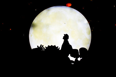 Silhouette shadow of traveler thai women people portrait posing for take photo with full moon and lighting star background outdoor in Furong Zhen and Tujia ancient town at Yongshun city in Hunan Chinaの写真素材