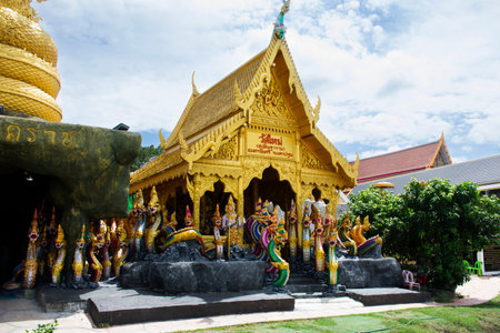 Golden color shrine holy naga of Wat Maisupradit Tharam temple for thai people travelers visit respect praying blessing deity myth worship at Nakhon Chai Si on May 24, 2024 in Nakhon Pathom, Thailandのeditorial素材