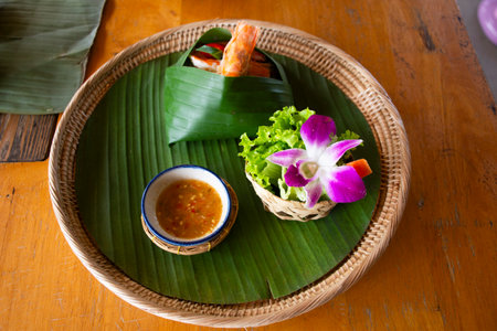 Traditional thai fusion street food and new cultural cuisine Pad Thai and shrimp or stir fried rice noodles with egg and prawns and vegetable mix spices sauce at local restaurant in Bangkok, Thailandの写真素材