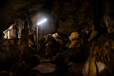 Ancient tunnel cave for thai people travelers visit respect praying blessing antique buddha and...