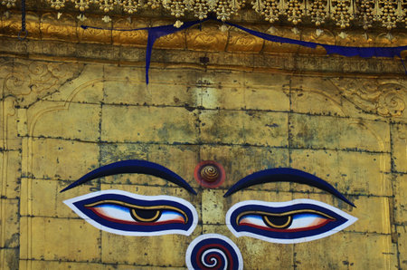 Buddha eyes or wisdom eyes symbol in Buddhist art on Antique Boudha Stupa of Boudhanath ancient temple for nepali people foreign travelers travel visit respect praying deity angel in Kathmandu, Nepalの写真素材