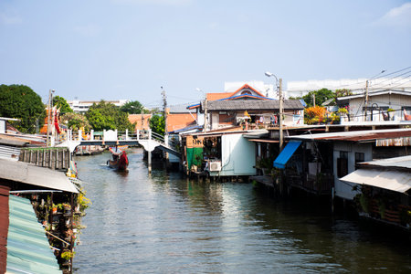 Thai helmsman sail long tail boat tour in Khlong Bang Luang for travelers people travel visit Floating Market and Artist House Bangkok with antique retro home and life lifestyle in Bangkok, Thailandの写真素材