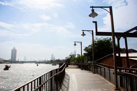 View landscape chao phraya river and cityscape with footpath walkway bridge on riverside for thai traveler people walking travel visit village of town historic in Bangkok, Thailandの写真素材