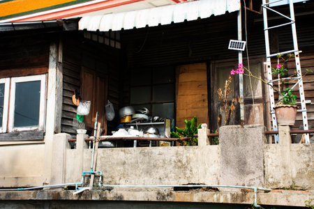 Life and lifestyle of local people with vintage retro interior kitchen room of ancient wooden house or antique wood home in Kadi Chin village at Kudi Chin or Kudeejeen town in Bangkok, Thailandの写真素材