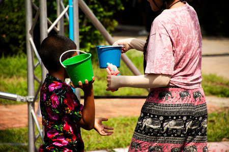 Local children thai people and travelers kids boy and girl journey to travel visit and happy playing splashing fights water in Songkran Festival or thai new year in Ayutthaya, Thailandの写真素材