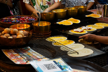 Traditional local thai food dessert Khanom bueang crispy pancake or thai crepes snack with variety sweets topping for people travelers select buy eat drink at street market bazaar in Bangkok, Thailandの写真素材