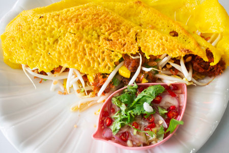 Traditional Vietnamese street food Savory Crepe or sizzling pancake cuisine meal stir fried rice noodles with egg and vegetable mix spices sauce at local restaurant cafe shopの写真素材