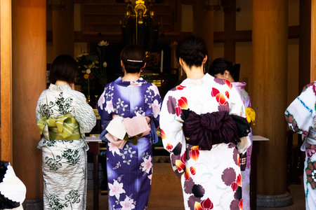 Travelers japanese women people wear traditional clothes kimono yukata travel visit respect praying blessing worship Ancient angel deity in antique shrine of Sensoji temple at Asakusa in Tokyo, Japanの写真素材