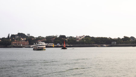 View landscape seascape Lujiang river with ferry boat and cityscape urban area Gulangyu Island or Town of Pianos for chinese people traveler travel visit at Xiamen on October 17, 2025 in Fujian, Chinaの写真素材