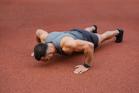 Athlete training in the open air. Workout on the playground.の写真素材