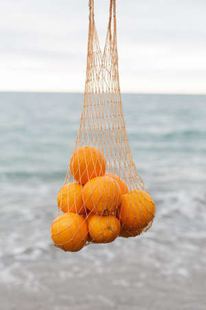 Ripe oranges on the background of the seaの写真素材