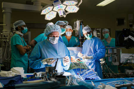 Surgeons in the operating room with a patient