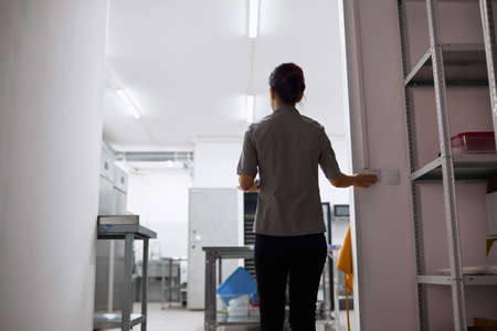 A bright pastry chef girl is preparing for a working dayの写真素材