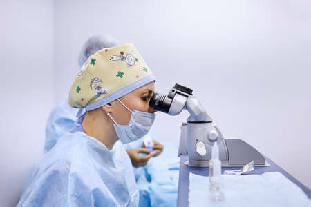 The surgeon uses a microscope during surgery