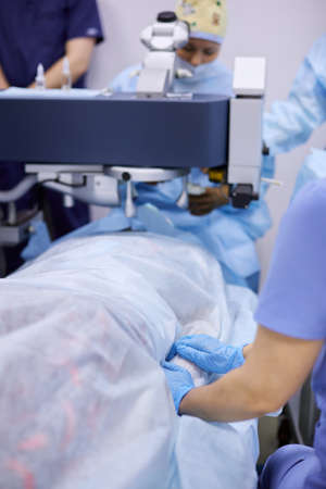 Surgeons performing eye surgery in the operating roomの写真素材