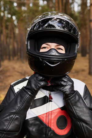 Portrait of a girl in a motorcycle helmetの写真素材