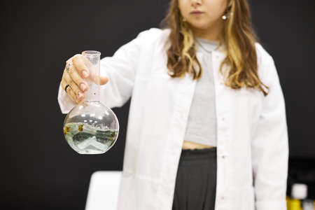 A girl laboratory assistant conducts a laboratory experimentの写真素材