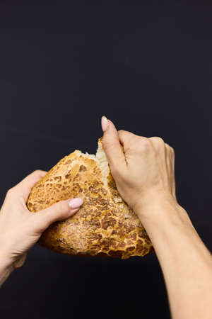 Woman holding tasty fresh bread, close up