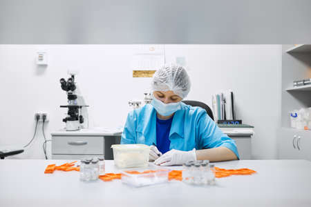Women work in the lab. Conducts experiments on vaccines.