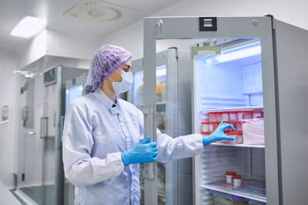 A girl scientist checks a sample for research