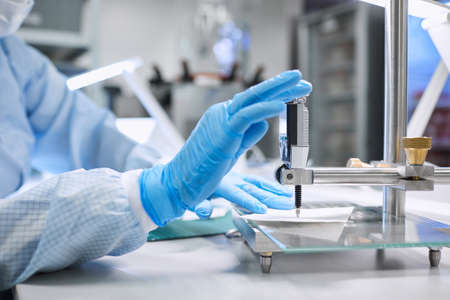 A female scientist takes measurements in the laboratoryの写真素材