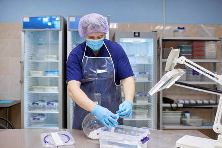 A laboratory assistant conducts research with biomaterial in the laboratory.