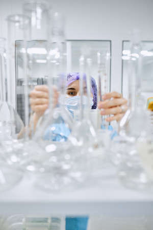 A girl scientist checks a sample for research