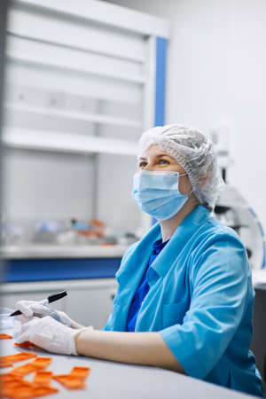 Women work in the lab. Conducts experiments on vaccines.