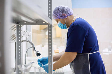 A laboratory worker checks the condition of the samples before testingの写真素材
