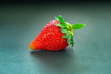 Strawberry on black background. Shallow depth of field.の写真素材