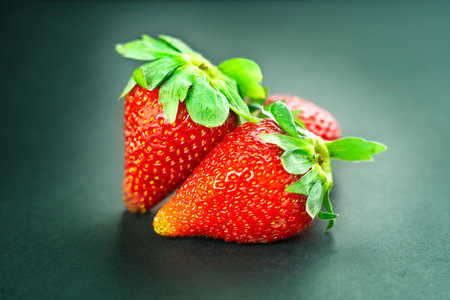 Strawberries on black background, close up shot with selective focusの写真素材