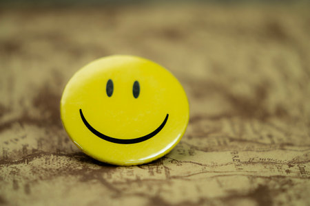 Smiling face on a vintage world map. Selective focus.の写真素材