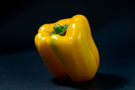 Yellow bell pepper on a black background, close-up, selective focusの写真素材