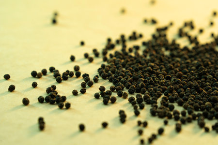 Black pepper on a wooden table. Selective focus. Shallow depth of field. Toned.