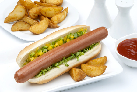 Chicken Jumbo Hotdog sandwich with fries & Ketchup on white plateの写真素材