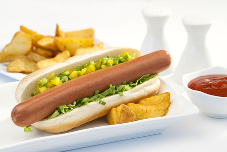 Chicken Jumbo Hotdog sandwich with fries & Ketchup on white plateの写真素材