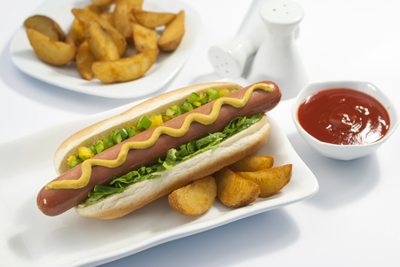 Chicken Jumbo Hotdog sandwich with fries & Ketchup on white plateの写真素材