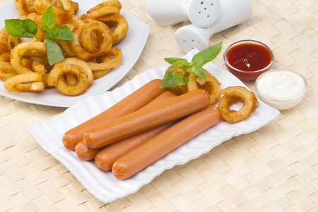 Chicken franks with potato swirls basil and ketchup with mayonnaiseの写真素材