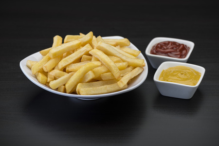 French fries with condimentsの写真素材