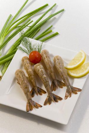 Raw prawns arranged on a plateの写真素材