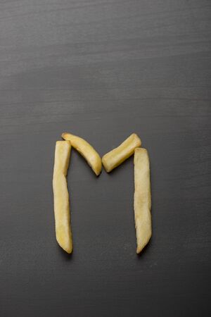 Alphabet M formed by french friesの写真素材