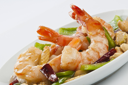 cajun Shrimps with cashew nuts stir fry vegetables on white plate with white backgroundの写真素材