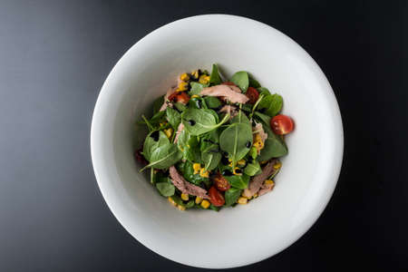 Tuna Salad in white bowl on wooden tableの写真素材
