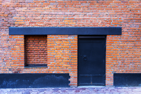 Window bricked up and a steel doorの写真素材