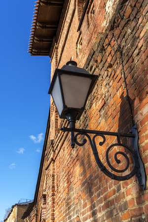 Vintage lantern on a red brick wall. on blue sky backgroundの写真素材